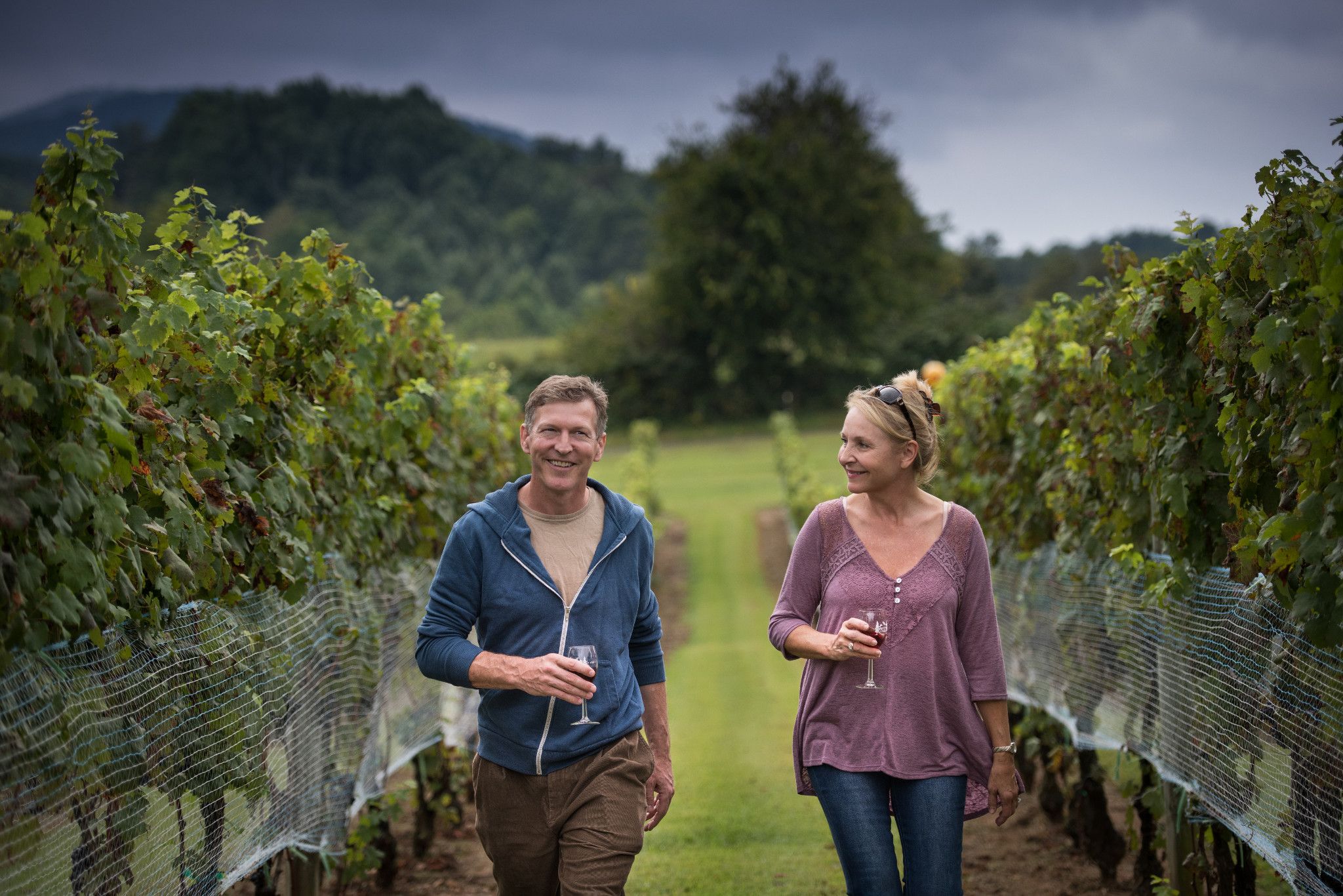 Couple in Vineyards with Wine