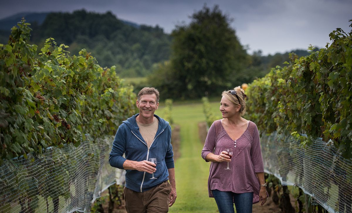 Couple in Vineyards with Wine