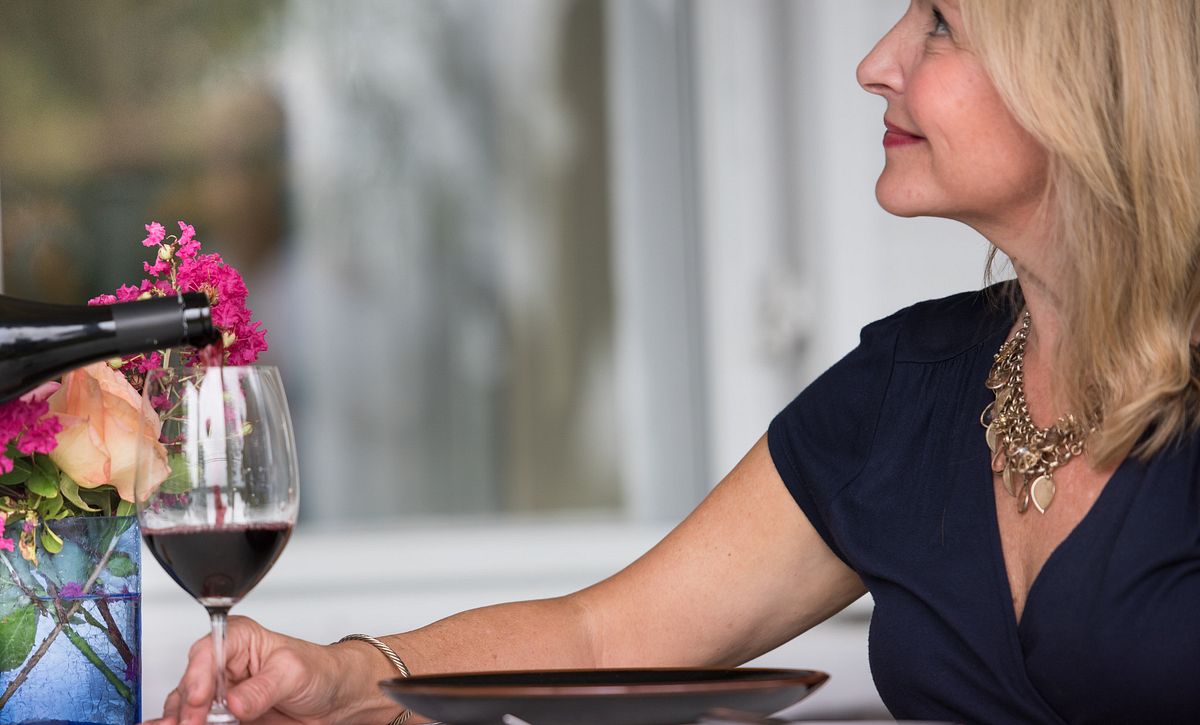 Woman being served a glass of wine