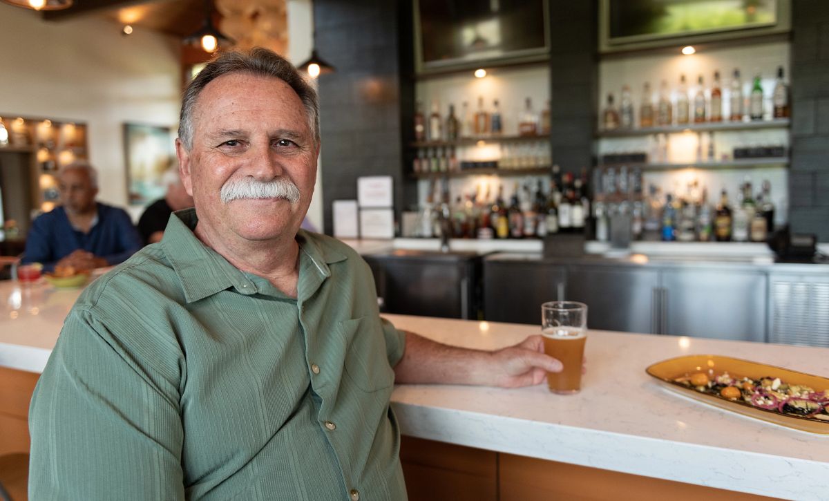 man with a beer at a bar 
