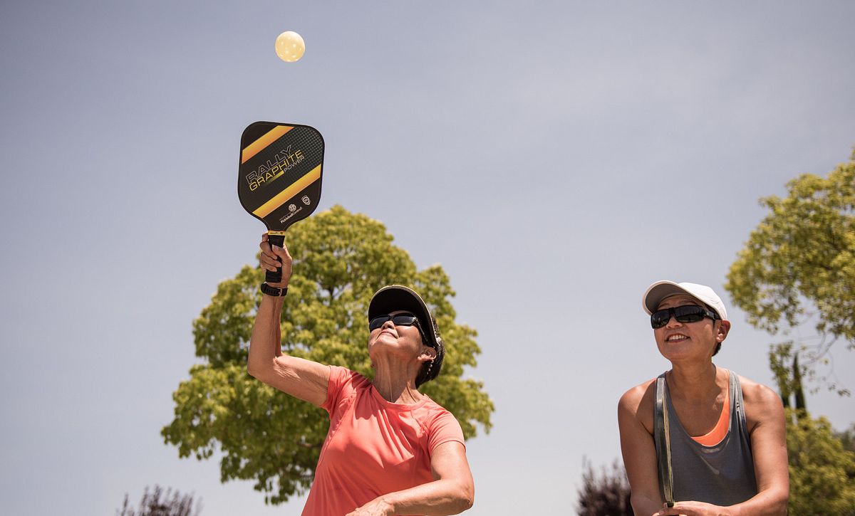 two gals playing pickleball